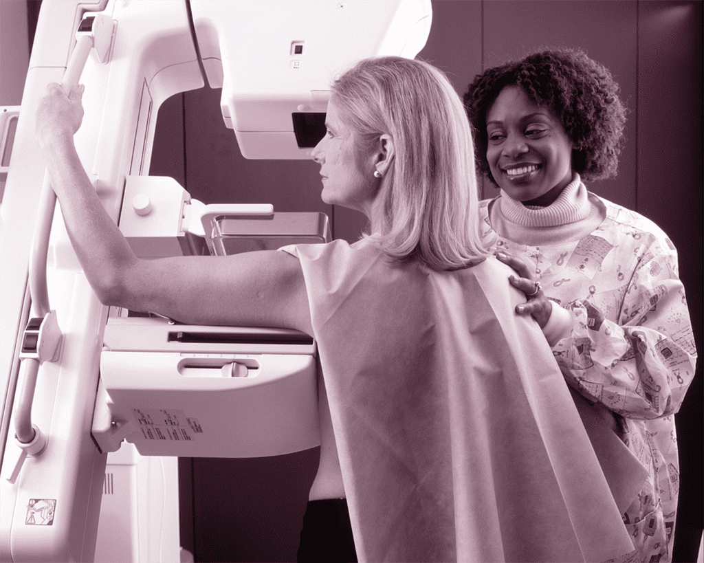 Breast Cancer Diagnosis, stages of breast cander; a woman getting a mammogram as a doctor looks on
